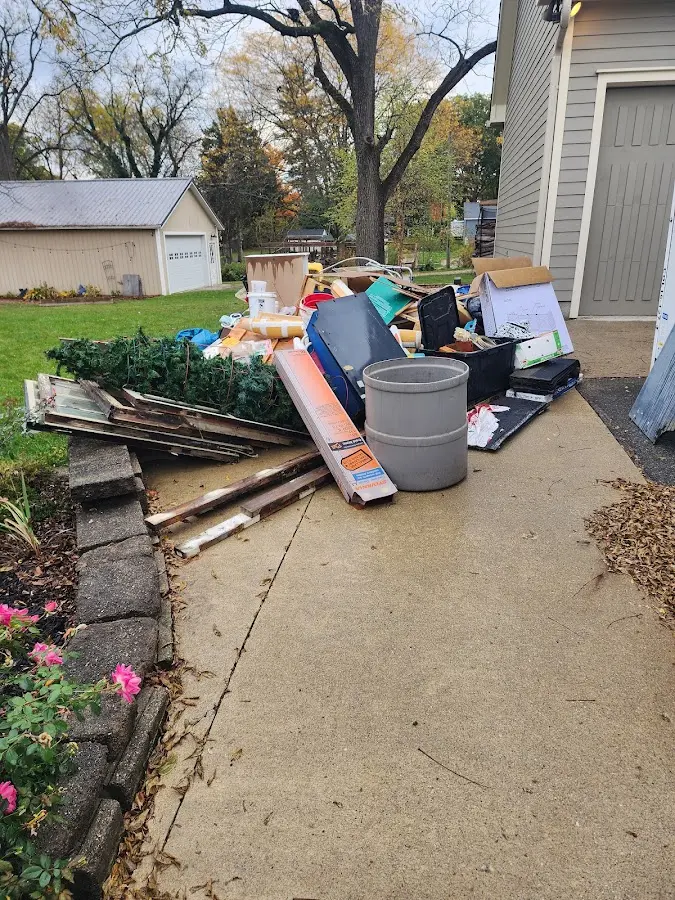 Dumpster being loaded with debris for Roofing Dumpster Rental in Grantsville